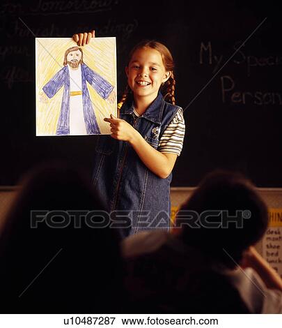 Stock Photo - Child with picture of Jesus. Fotosearch