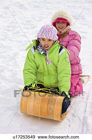 Children tobogganing View Large Photo Image Stock Photo - Children tobogganing . Fotosearch