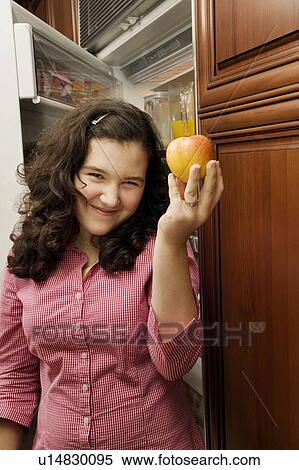 Stock Photography - Girl with an apple. Fotosearch