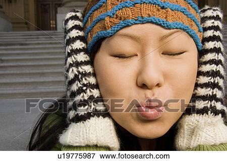 Stock Photo - Girl with eyes closed ready for a kiss. Fotosearch