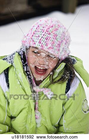 Stock Image - Girl with snow covered face. Fotosearch