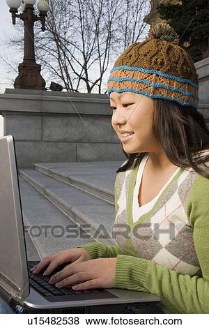 Girl working on computer outside View Large Photo Image Stock Photo - Girl working on computer outside. Fotosearch