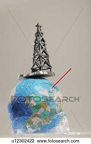 Stock Image - Globe in ice with straw and oil drilling rig. Fotosearch