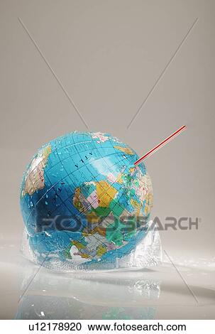 Stock Image - Globe in ice with straw. Fotosearch