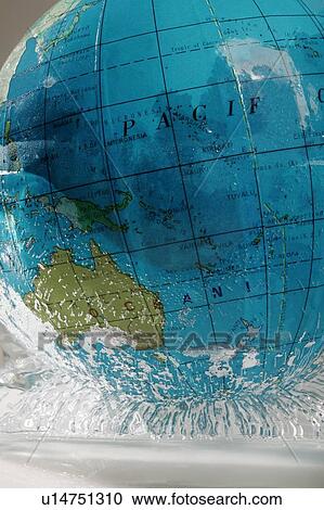 Stock Image - Globe in melting ice. Fotosearch