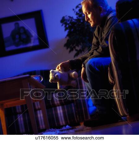 Man looking at teddy bear View Large Photo Image Stock Photography - Man looking at teddy bear. Fotosearch