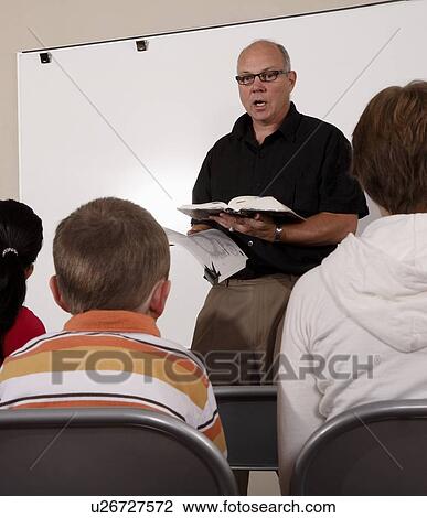 Stock Image - Man teaching students. Fotosearch