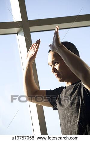 Man with his hands raised View Large Photo Image Stock Photo - Man with his hands raised. Fotosearch