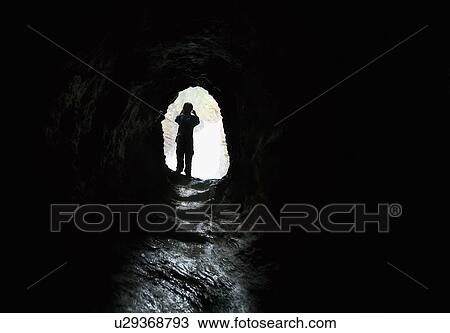 Person walking out of a tunnel View Large Photo Image Stock Image - Person walking out of a tunnel. Fotosearch