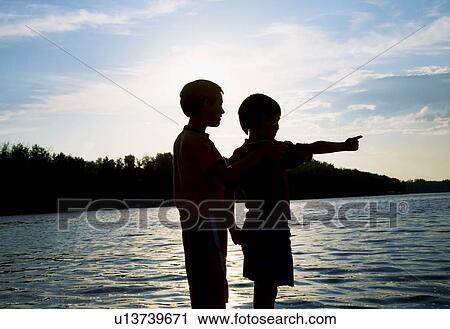 Silhouette of children by a beach View Large Photo Image Stock Image - Silhouette of children by a beach. Fotosearch