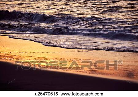 Sunset reflected on wet sand View Large Photo Image Stock Photography - Sunset reflected on wet sand. Fotosearch