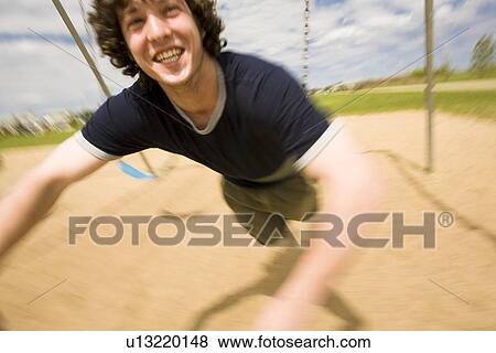 Teenage boy at the playground View Large Photo Image Stock Photo - Teenage boy at the playground. Fotosearch