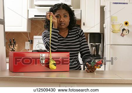 Woman looking hopeless with toolbox and tools View Large Photo Image Stock Image - Woman looking hopeless with toolbox and tools. Fotosearch