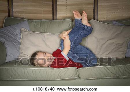 Stock Image - A boy on a couch. Fotosearch