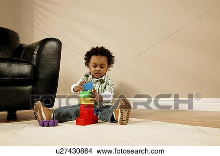 A boy playing with blocks View Large Photo Image Picture - A boy playing with blocks. Fotosearch