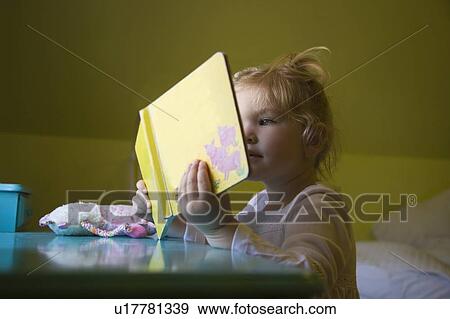 Stock Photo - A girl reading a book. Fotosearch