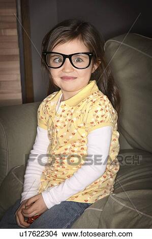 A girl wearing glasses, crossing her eyes View Large Photo Image Picture - A girl wearing glasses, crossing her eyes. Fotosearch