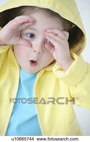 A little girl in a raincoat View Large Photo Image Picture - A little girl in a raincoat. Fotosearch