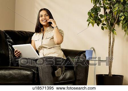 Stock Photography - A woman talking on the phone. Fotosearch