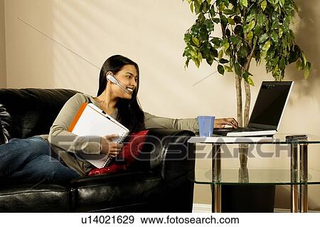 A woman using a laptop View Large Photo Image Stock Photo - A woman using a laptop. Fotosearch