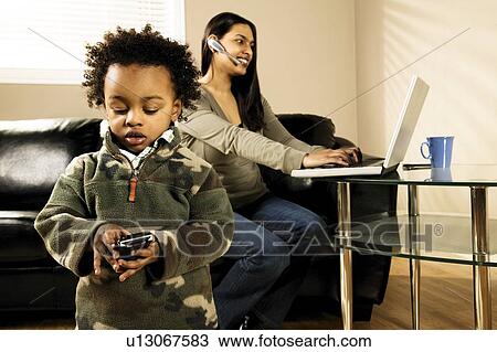 Stock Image - A woman working at home. Fotosearch