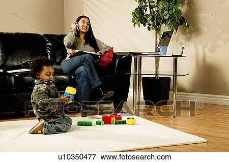 Stock Photo - A woman working at home. Fotosearch