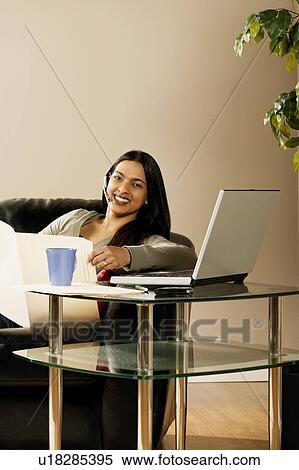 A woman working at home View Large Photo Image Stock Photography - A woman working at home. Fotosearch
