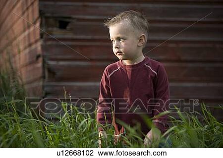 A young boy in tall grass View Large Photo Image Stock Image - A young boy in tall grass. Fotosearch
