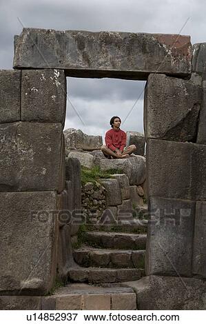 A young man meditates in ancient Incan ruins outside Cuzco, Peru View Large Photo Image Stock Photo - A young man meditates in ancient Incan ruins outside Cuzco, Peru. Fotosearch