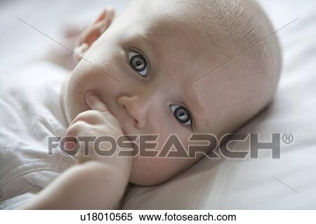 Stock Photography - Baby boy sucking on fingers. Fotosearch