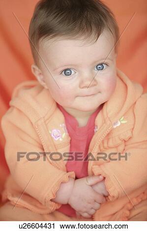 Baby in orange jacket View Large Photo Image Stock Image - Baby in orange jacket. Fotosearch