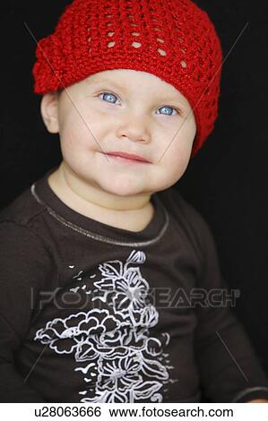 Stock Photograph - Baby in red hat. Fotosearch