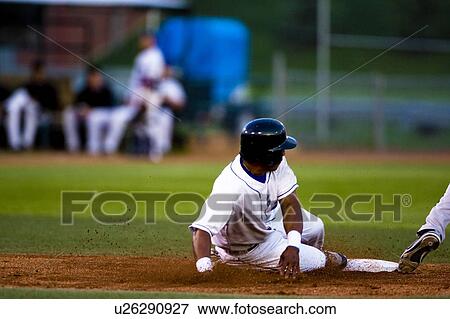 Stock Photo - Baseball player sliding onto a base. Fotosearch