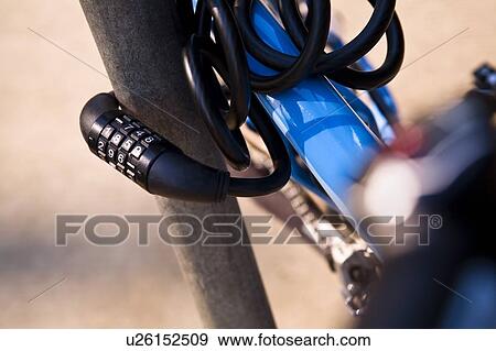 Bike locked to a pole View Large Photo Image Stock Photo - Bike locked to a pole. Fotosearch