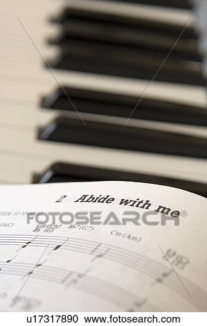 Book of music open on piano, close up View Large Photo Image Stock Image - Book of music open on piano, close up. Fotosearch