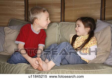 Boy and girl playing on a couch View Large Photo Image Stock Photography - Boy and girl playing on a couch. Fotosearch