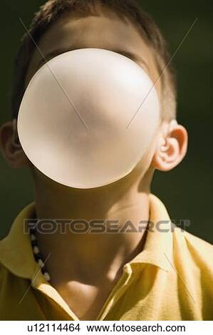Picture - Boy blowing bubble with bubblegum. Fotosearch