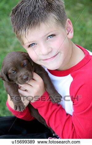 Boy holding puppy View Large Photo Image Stock Photo - Boy holding puppy. Fotosearch