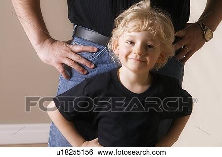 Stock Photograph - Boy with adult standing behind. Fotosearch