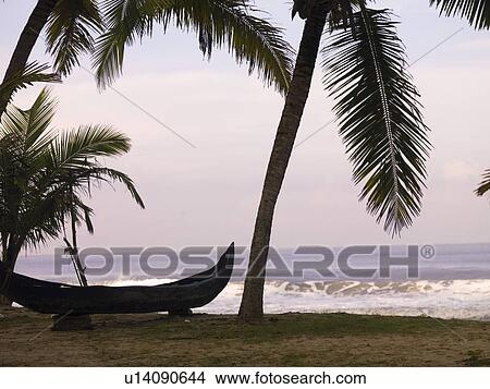 Picture - Canoe on the beach, Arabian Sea, Kerala, India . Fotosearch