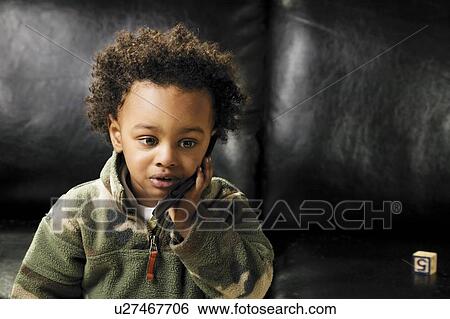 Stock Photograph - Child with cell phone. Fotosearch
