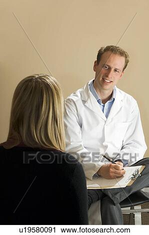 Chiropractor with his patient View Large Photo Image Stock Image - Chiropractor with his patient. Fotosearch