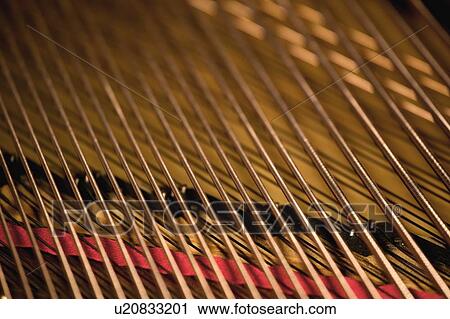 Stock Image - Close up of piano strings. Fotosearch