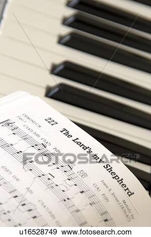 Close up of sheet music on piano keyboard View Large Photo Image Stock Photo - Close up of sheet music on piano keyboard. Fotosearch