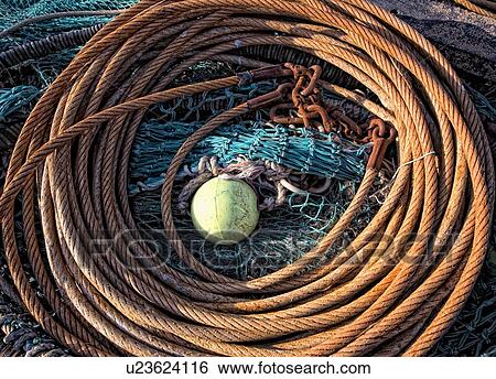 Coil of rope and fishing nets View Large Photo Image Stock Photograph - Coil of rope and fishing nets. Fotosearch
