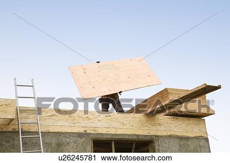 Construction worker carrying plywood View Large Photo Image Stock Image - Construction worker carrying plywood. Fotosearch