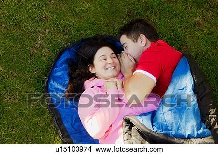 Picture - Couple in a sleeping bag. Fotosearch