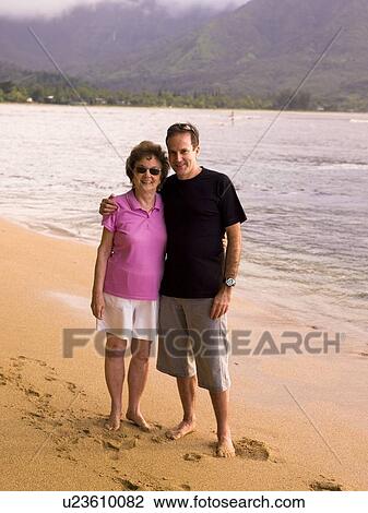 Couple on beach in Kauai, Hawaii, USA View Large Photo Image Stock Image - Couple on beach in Kauai, Hawaii, USA. Fotosearch