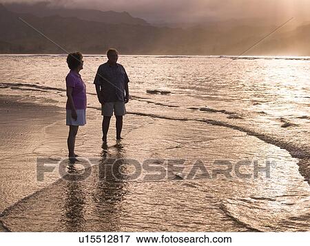 Stock Photo - Couple on the beach in Kauai, Hawaii, USA. Fotosearch
