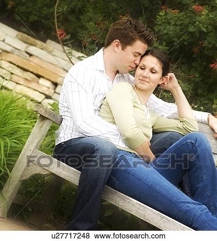 Stock Photo - Couple sitting on a bench. Fotosearch